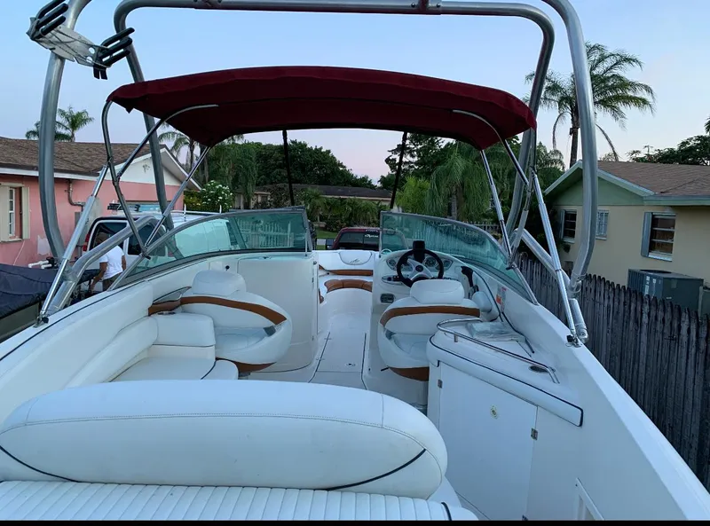 Slide: The Image of 2006 Monterey 268SS Super Sport boat with red canopy and white seating. - 5