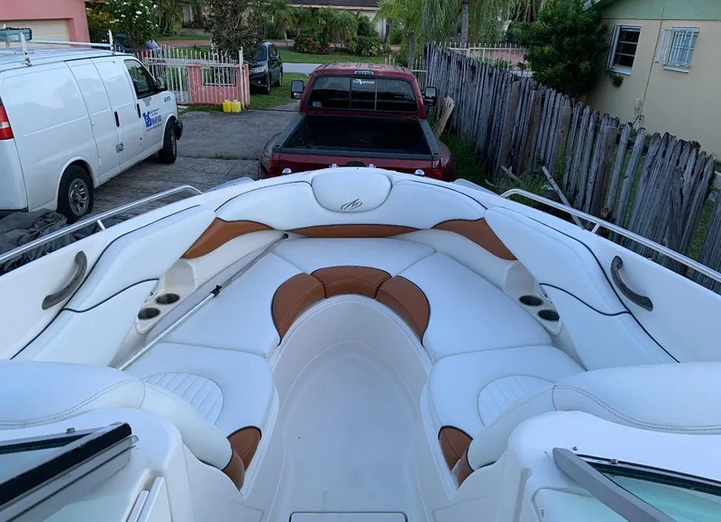 Slide: The Image of 2006 Monterey 268SS Super Sport boat with white and brown seating in a driveway. - 8
