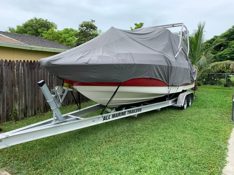 Slide: The Image of Covered 2006 Monterey 268SS Super Sport boat on trailer in grassy yard. - 9