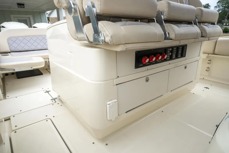 Slide: The Image of Interior view of 2018 Chris-Craft Catalina 34 boat with beige seating and control panel. - 10