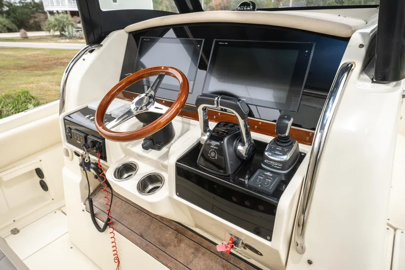 Slide: The Image of 2018 Chris-Craft Catalina 34 helm with wooden steering wheel and modern controls. - 11