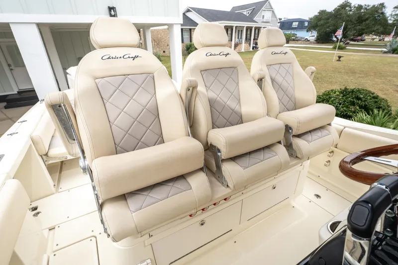 Slide: The Image of Luxurious seating on 2018 Chris-Craft Catalina 34 boat, featuring elegant beige upholstery. - 12