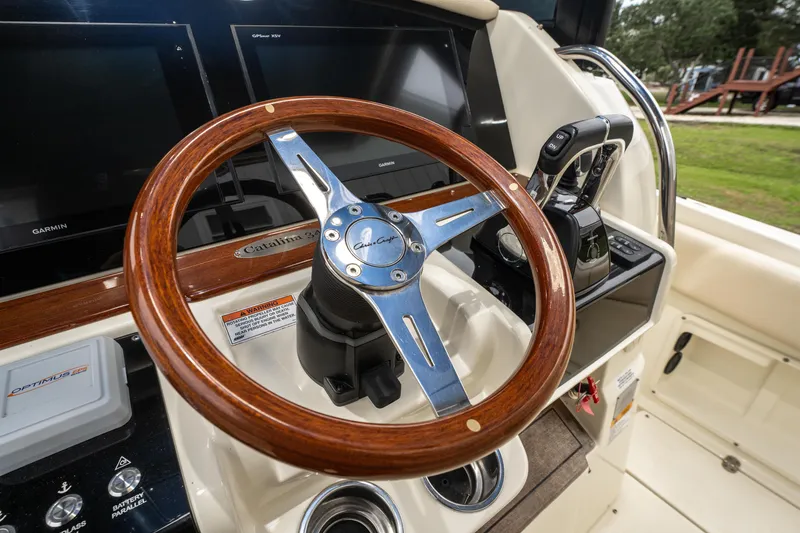 Slide: The Image of 2018 Chris-Craft Catalina 34 helm with wooden steering wheel and modern controls. - 13