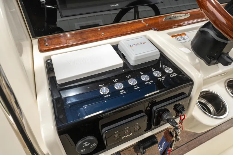 Slide: The Image of 2018 Chris-Craft Catalina 34 dashboard with controls and steering wheel. - 15