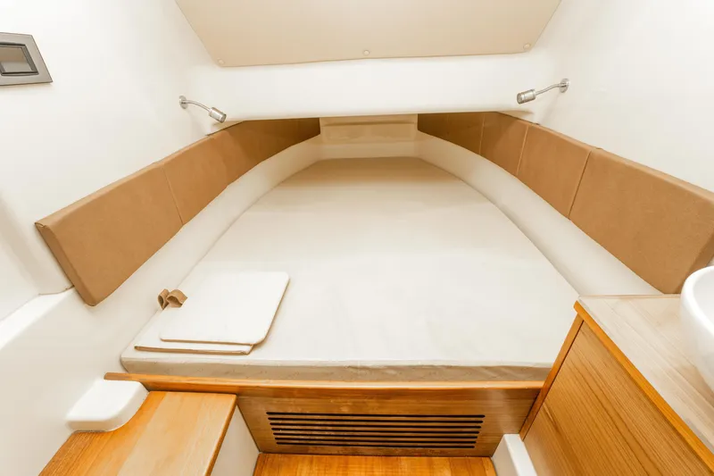 Slide: The Image of 2018 Chris-Craft Catalina 34 cabin interior with cozy bed and wooden accents. - 26