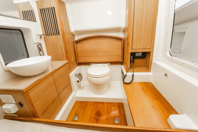 Slide: The Image of Luxurious 2018 Chris-Craft Catalina 34 bathroom with wood accents and modern fixtures. - 27