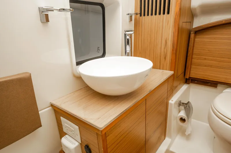 Slide: The Image of 2018 Chris-Craft Catalina 34 bathroom with modern sink and wooden cabinetry. - 28