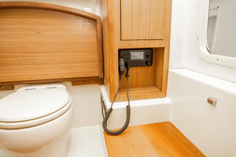 Slide: The Image of 2018 Chris-Craft Catalina 34 bathroom with wooden cabinetry and marine radio. - 29