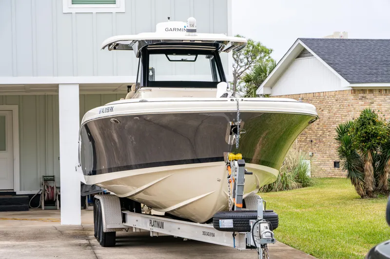 Slide: The Image of 2018 Chris-Craft Catalina 34 boat on trailer in residential driveway. - 31