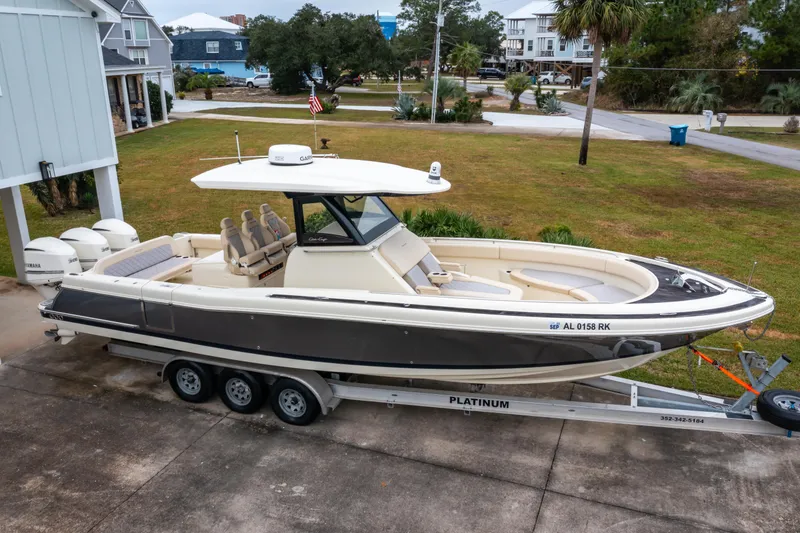 Slide: The Image of 2018 Chris-Craft Catalina 34 boat on trailer, parked in residential driveway. - 33