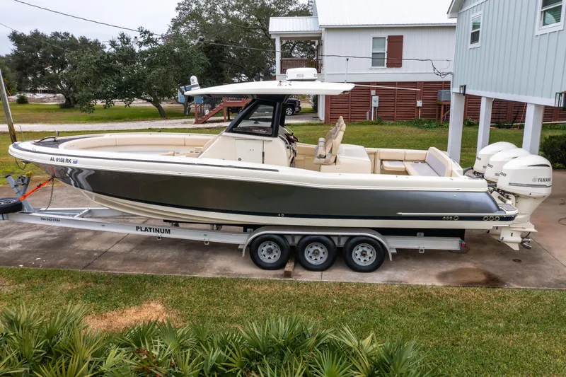 Slide: The Image of 2018 Chris-Craft Catalina 34 boat on trailer, parked in driveway. - 34