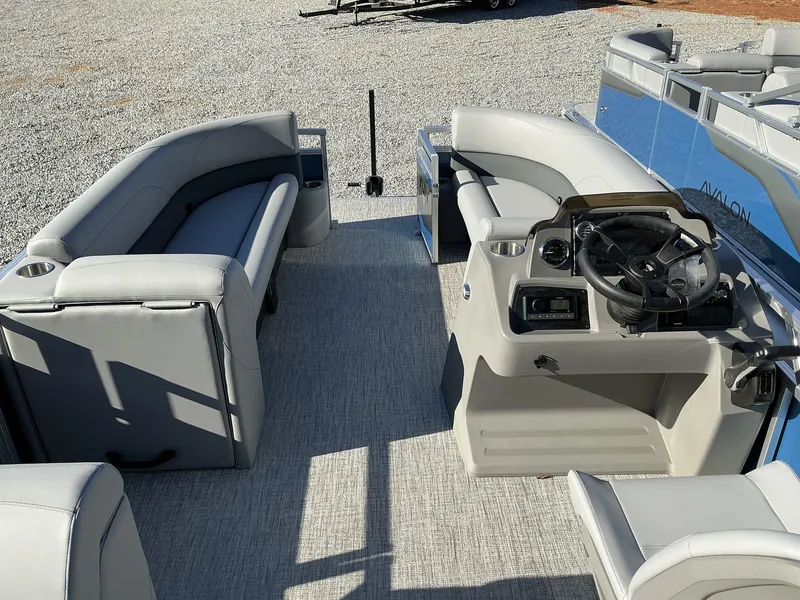 Slide: The Image of 2025 Avalon VLS 23 Quad Lounger interior with gray seating and steering console. - 13