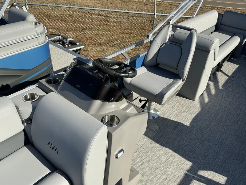 Slide: The Image of 2025 Avalon VLS 23 Quad Lounger boat interior with gray seating and steering console. - 5