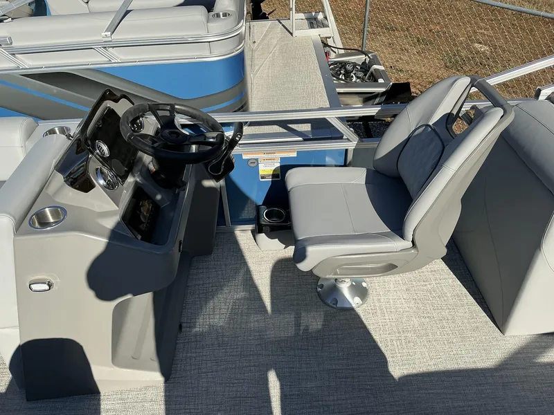 Slide: The Image of 2025 Avalon VLS 23 Quad Lounger boat interior with steering console and seating. - 7