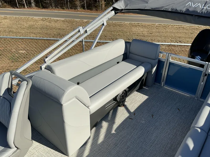 Slide: The Image of 2025 Avalon VLS 23 Quad Lounger boat interior with gray seating and canopy. - 8