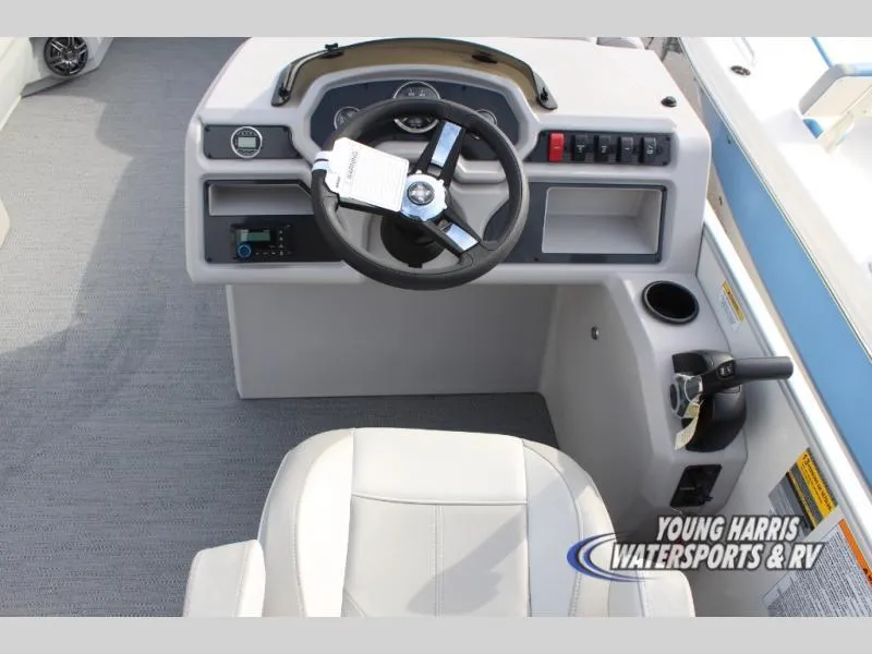Slide: The Image of 2025 Godfrey Sweetwater 2286SBX boat helm with steering wheel and controls. - 11