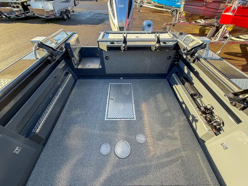 Slide: The Image of 2021 Hewescraft 220 Ocean Pro Hard Top boat interior with spacious deck and storage compartments. - 14