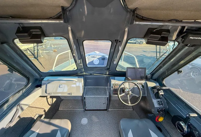 Slide: The Image of Interior view of 2021 Hewescraft 220 Ocean Pro Hard Top boat cockpit. - 7