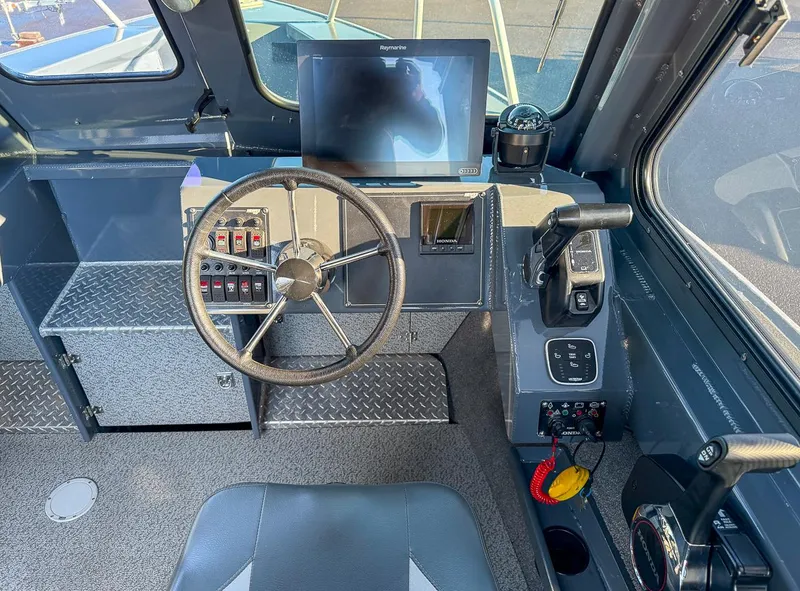 Slide: The Image of 2021 Hewescraft 220 Ocean Pro Hard Top boat cockpit with steering wheel and control panel. - 8