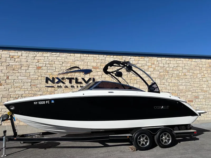 Slide: The Image of 2017 Cobalt R5 boat on trailer, parked at NXT LVL Marine, clear blue sky. - 1