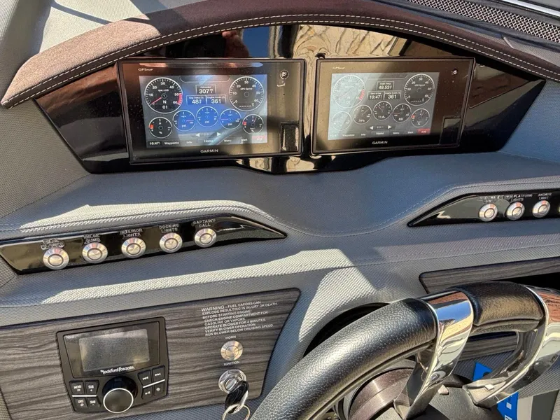 Slide: The Image of Dashboard of a 2017 Cobalt R5 boat with Garmin displays and control switches. - 12