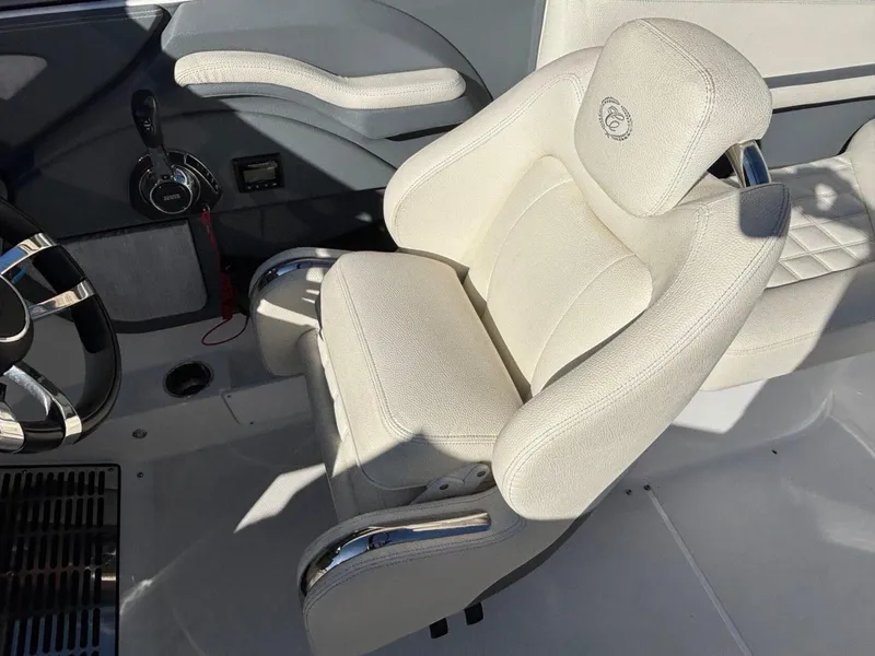 Slide: The Image of 2017 Cobalt R5 boat interior with white captain's chair and steering wheel. - 17