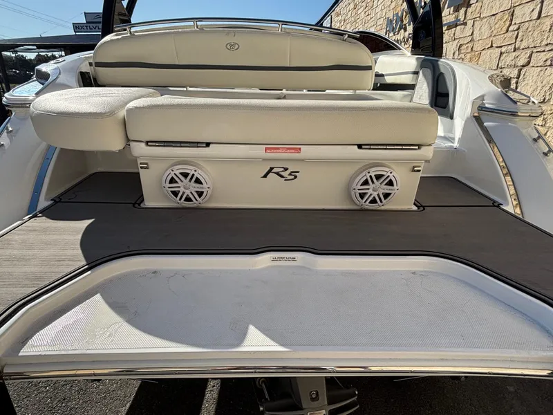 Slide: The Image of 2017 Cobalt R5 boat rear view with speakers and cushioned seating. - 23