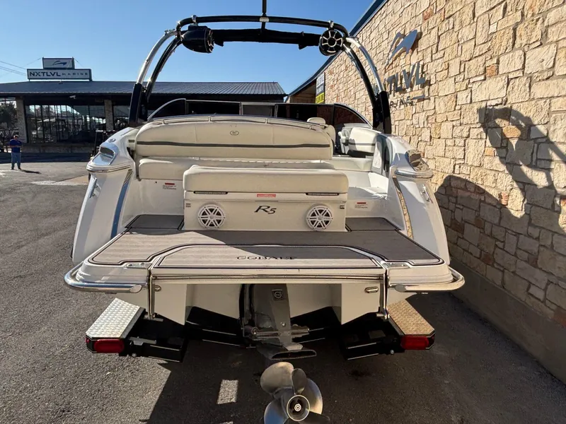Slide: The Image of 2017 Cobalt R5 boat rear view at marina, showcasing swim platform and seating. - 5