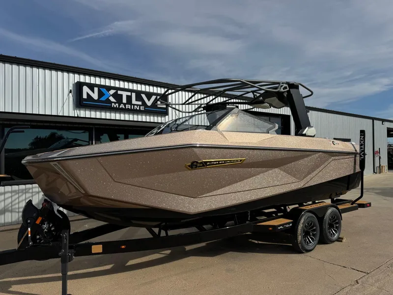 Slide: The Image of 2025 Nautique G23 boat on trailer at NXT LVL Marine dealership. - 10