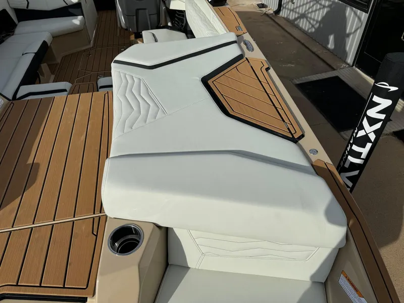 Slide: The Image of 2025 Nautique G23 boat interior with sleek white seating and teak flooring. - 12