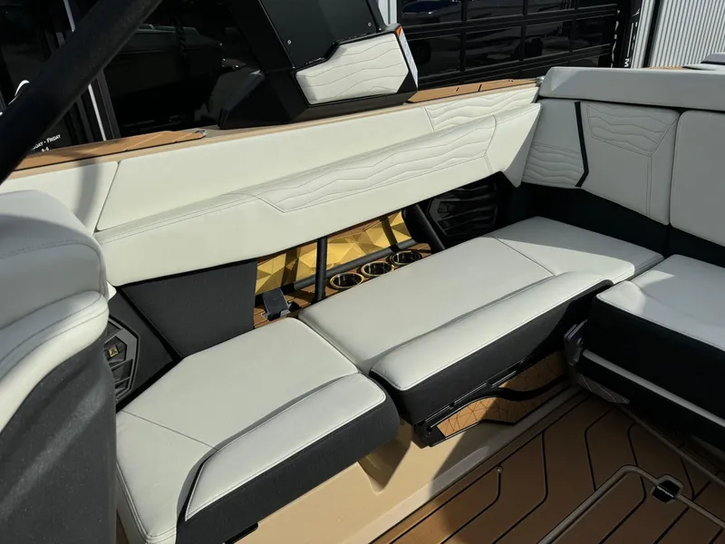 Slide: The Image of 2025 Nautique G23 interior with luxurious white seating and modern design elements. - 16