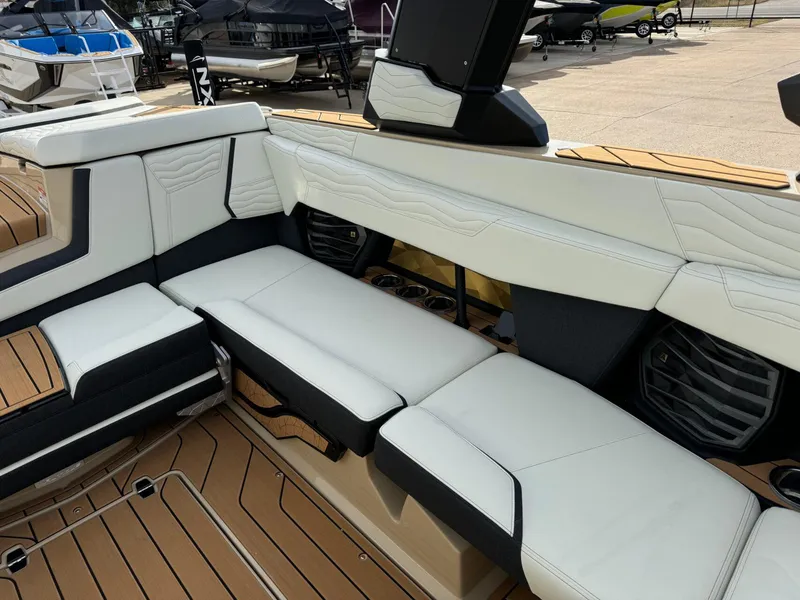 Slide: The Image of 2025 Nautique G23 boat interior with white seating and teak flooring. - 18