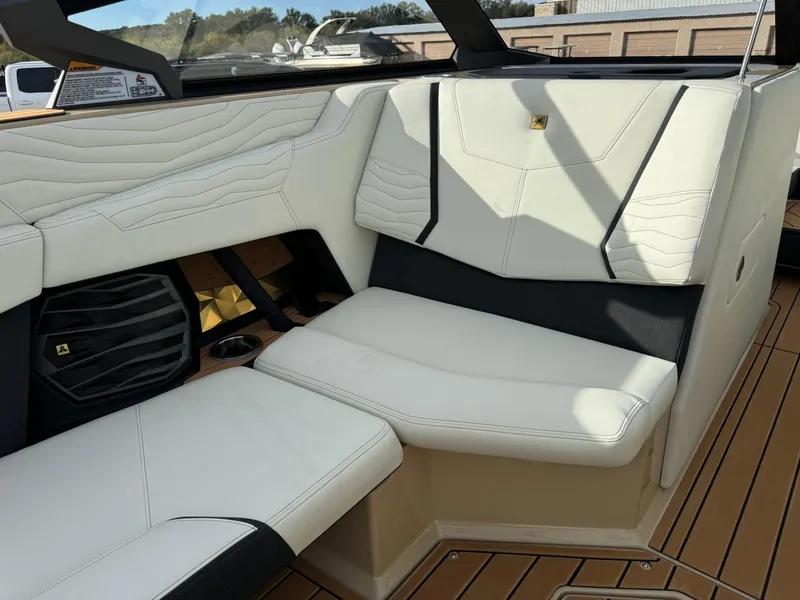 Slide: The Image of 2025 Nautique G23 interior with white leather seating and modern design elements. - 19