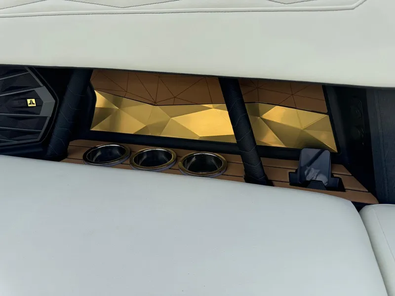 Slide: The Image of 2025 Nautique G23 interior detail with cup holders and geometric design accents. - 21