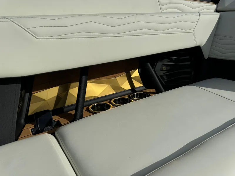 Slide: The Image of 2025 Nautique G23 interior with luxurious seating and cup holders. - 23