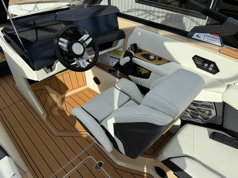 Slide: The Image of 2025 Nautique G23 boat interior with modern steering and luxurious seating. - 25
