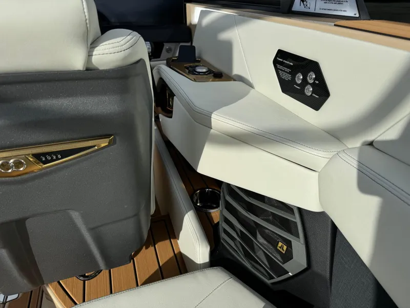 Slide: The Image of 2025 Nautique G23 interior with luxurious seating and modern control panel. - 27