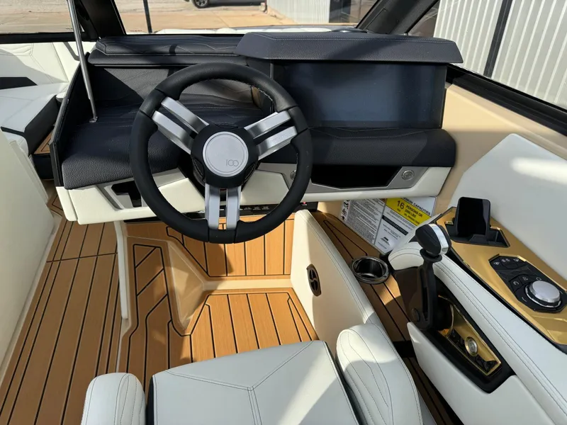 Slide: The Image of 2025 Nautique G23 boat interior with modern steering wheel and sleek dashboard design. - 29