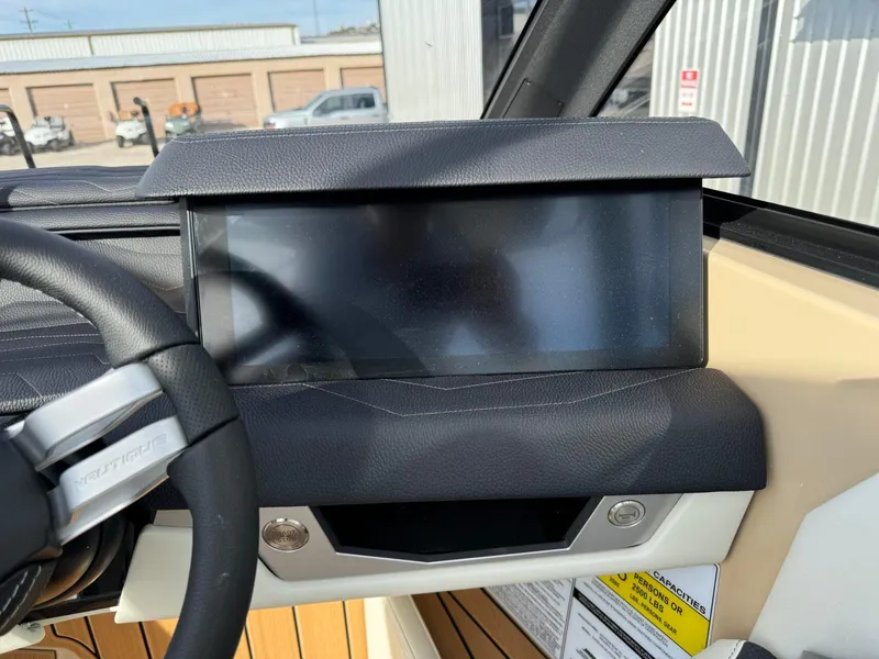Slide: The Image of 2025 Nautique G23 dashboard with touchscreen display and steering wheel detail. - 30