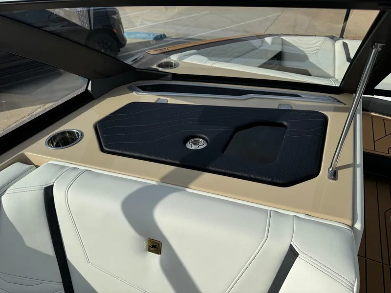 Slide: The Image of 2025 Nautique G23 interior with sleek dashboard and cup holder. - 32