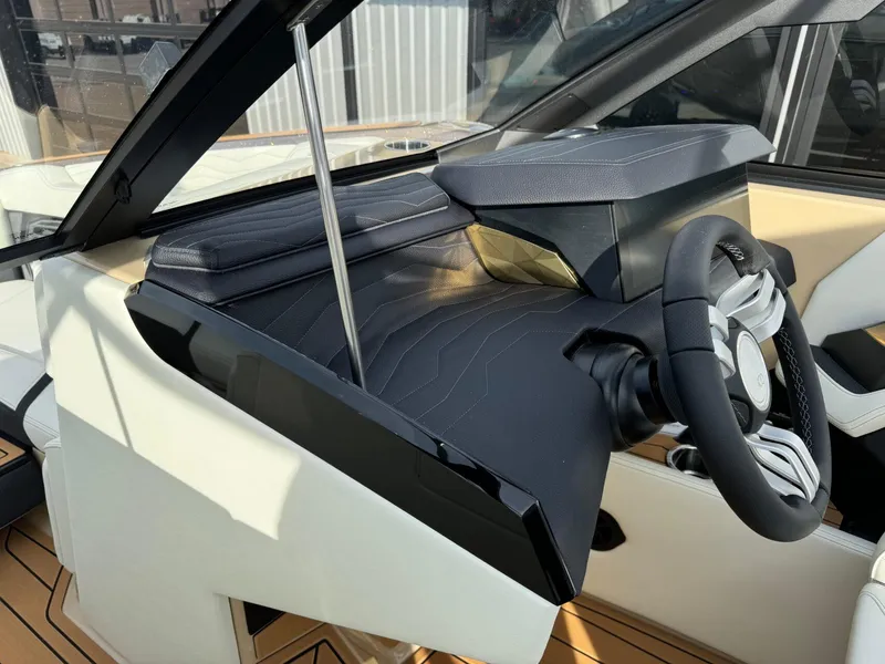 Slide: The Image of 2025 Nautique G23 boat dashboard with modern steering wheel and sleek design. - 33