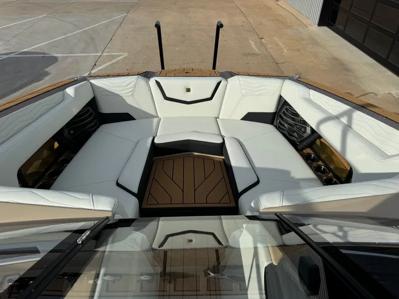 Slide: The Image of 2025 Nautique G23 boat interior with white seating and wood accents. - 34