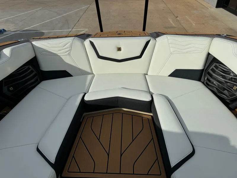 Slide: The Image of 2025 Nautique G23 boat interior with white seating and teak flooring. - 36