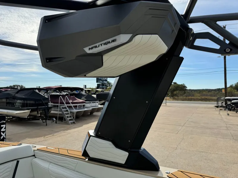 Slide: The Image of 2025 Nautique G23 boat speaker system, docked with other boats in the background. - 41