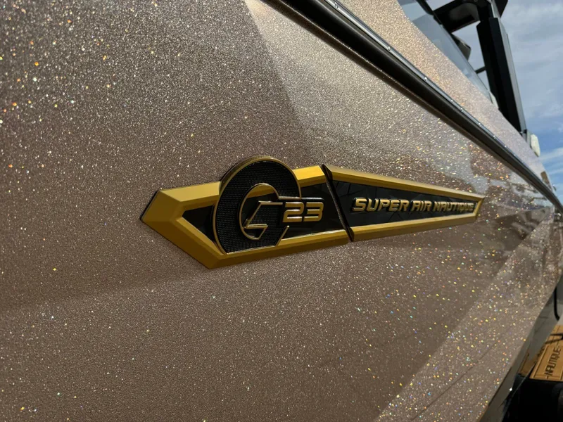 Slide: The Image of 2025 Nautique G23 Super Air Nautique boat with glittering exterior finish. - 9