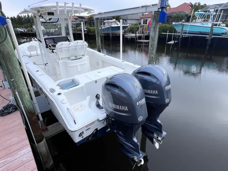 Slide: The Image of 2017 Sea Hunt Gamefish 25 boat with twin Yamaha 150 engines docked in marina. - 10