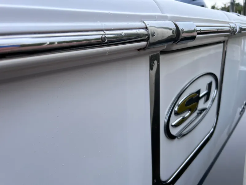 Slide: The Image of Close-up of 2017 Sea Hunt Gamefish 25 boat, showcasing sleek design and logo. - 11