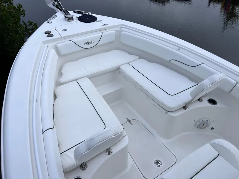 Slide: The Image of 2017 Sea Hunt Gamefish 25 boat interior with white cushioned seating, clean and well-maintained. - 12
