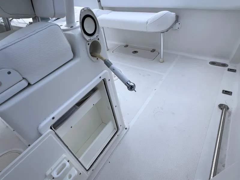 Slide: The Image of 2017 Sea Hunt Gamefish 25 interior, clean deck with storage and seating. - 16