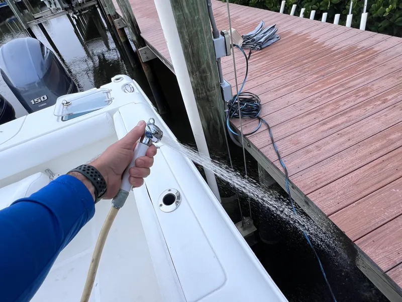 Slide: The Image of Cleaning a 2017 Sea Hunt Gamefish 25 boat with a hose at the dock. - 17